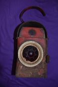 A vintage road side marking or repairs lamp having red glass dated 1960