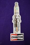 A vintage garage sign for Champion Spark Plugs