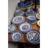 A good selection of various blue and white willow wear plates and bowls