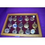 A glazed display case containing fifteen pocket watches or time pieces