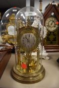 A German made anniversary clock in glass dome, Jahresumrenfabrik in gothic style