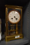 A brass cased Edwardian mantle clock having four glass window with mercury pendulum possibly