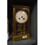 A brass cased Edwardian mantle clock having four glass window with mercury pendulum possibly