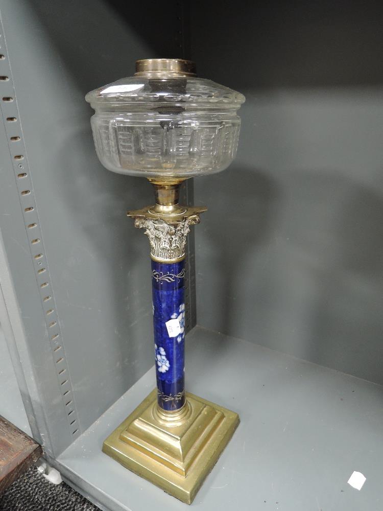 An elegant Victorian oil lamp having hand decorated Roman style column with ormolu decoration