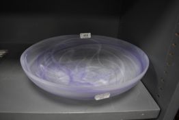 A smoked art glass bowl having white and purple hues