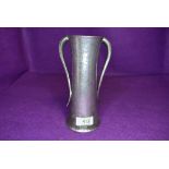 An arts and crafts style Tudric pewter vase having hammered body with double tapered arms 18cm tall