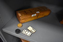 A cribbage box and board with box wood draughts and ebony and bone dominoes