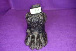 A cast iron animal paw ideal as door stop
