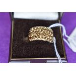 A gents 9ct gold ring having plait and ball decoration, size S & APPROX 6.2G