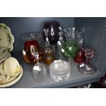 A selection of clear cut and colour art glass including large brandy or wine glass and bells