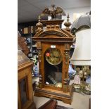 A German framed 8 day steeple clock with carved decoration