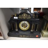 A marble mantel clock with Greek column design