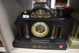 A marble mantel clock with Greek column design