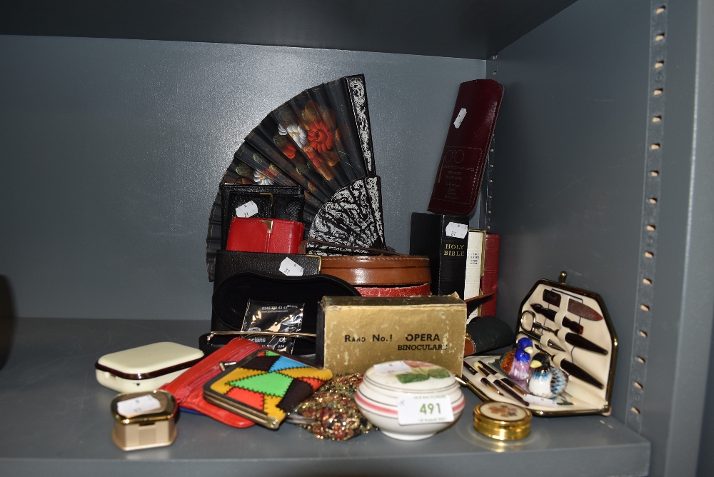 A selection of curios and dressing items including fans coin purse and manicure set