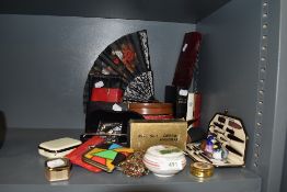 A selection of curios and dressing items including fans coin purse and manicure set