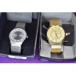 A gents gold plated fashion wrist watch by Christin Lars and a similar steel coloured wrist watch by
