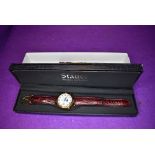 A gent's wrist watch by Stauer no:DS13373 having day, date, month and moon phase dials to face and