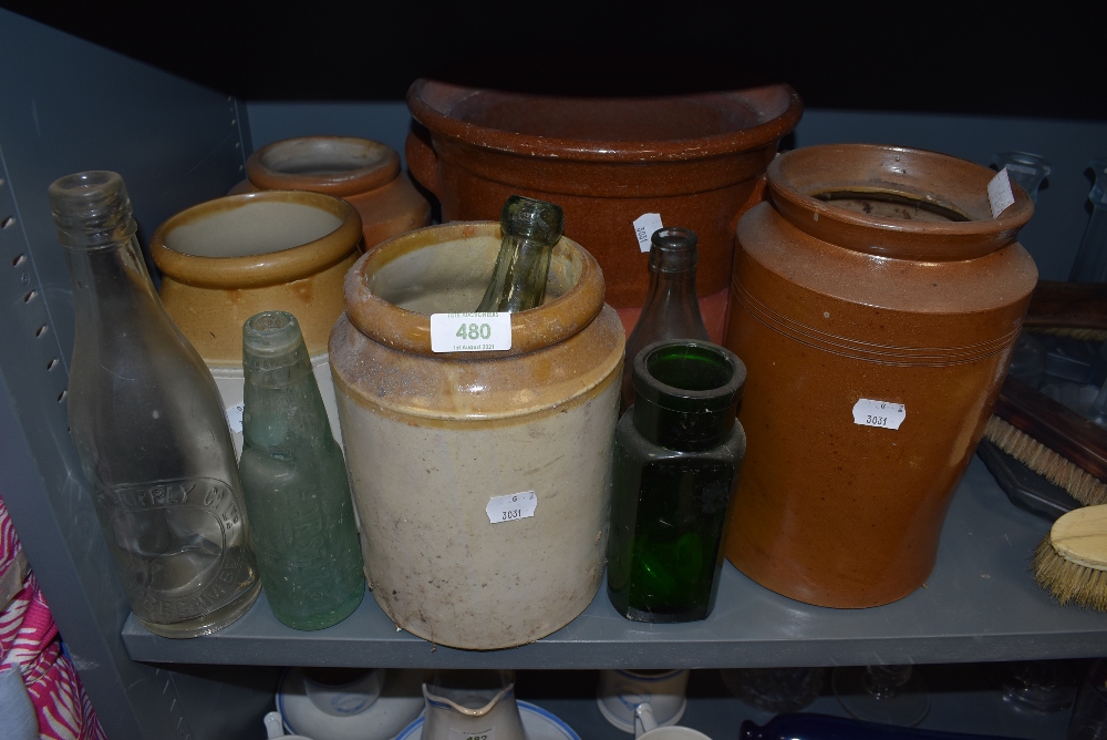 A selection of stoneware jars glass bottles and large salt glazed grain tub