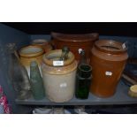 A selection of stoneware jars glass bottles and large salt glazed grain tub