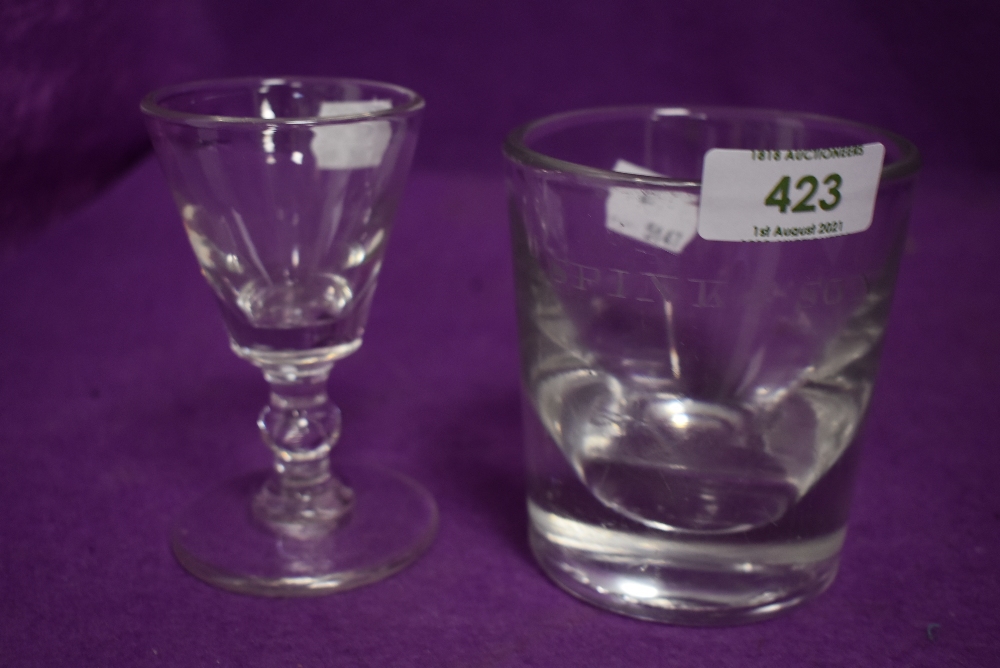 An antique heavy set whisky tumbler etched J Spink and Sons and similar baluster stem wine glass