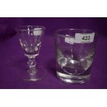 An antique heavy set whisky tumbler etched J Spink and Sons and similar baluster stem wine glass