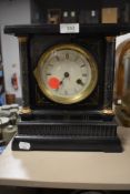 A Victorian 8 day mantel clock in wooden case with enamel face