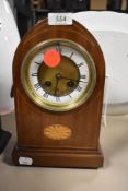 An inlaid bodied mantel clock with an enamel face