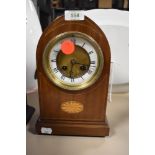 An inlaid bodied mantel clock with an enamel face