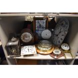 A shelf of clocks and parts (spares and repairs)