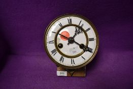 An enamel faced clock movement