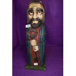 A wooden carved wine or bottle holder in form of a shepherd 40cm tall
