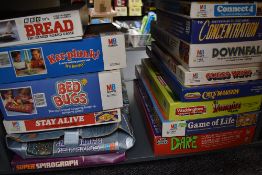 A shelf of vintage Games including Game of Life, Downfall, Ker Plunk, Bread, Stay Alive, Bed Bugs,