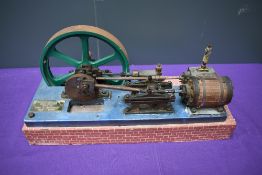 A Single Cylinder horizontal live steam model Mill Engine having spoked flywheel on wood base,