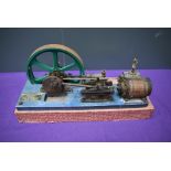 A Single Cylinder horizontal live steam model Mill Engine having spoked flywheel on wood base,