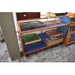 A vintage wood and glass display cabinet having three shelves