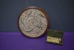 A Victorian circular wooden Snakes & Ladders Board made by F H Ayres London having red ladders and