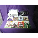 A Microsoft Xbox 360 console with one controller, power cable, head set and instruction booklet