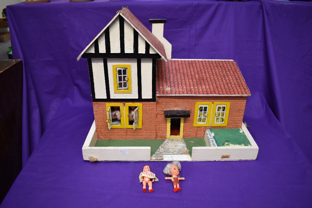 A hand made wooden Dolls House having two downstairs rooms and one bedroom along with hand made
