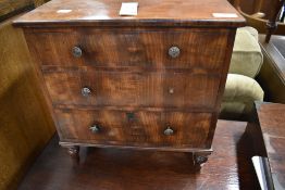 A 19th Century mahogany specimen chest of three long drawers, having shaped ledge back with some