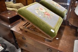An early 20th Century stained frame adjustable footstool having woolwork top
