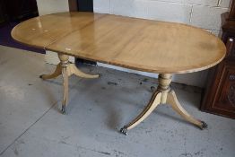 A nice quality reproduction Regency bleached mahogany two part extendable dining table having