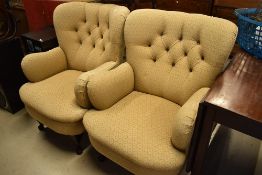 A pair of traditional easy chairs , having button backs on cabriole legs