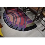 Two vintage demi lune hearth rugs, in vibrant colours