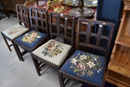 A set of four early 20th Century oak cullice back dining chairs