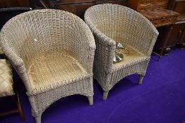 A pair of wicker woven conservatory tub chairs