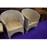 A pair of wicker woven conservatory tub chairs