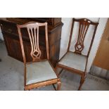 A pair of mahogany carved back dining chairs having cabriole legs