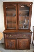 A Victorian secretaire book case having mahogany frame work with rolled glass front and decorative