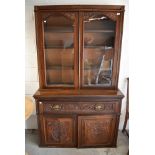 A Victorian secretaire book case having mahogany frame work with rolled glass front and decorative