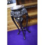 An Oriental hardwood plant stand having rouge marble inlay